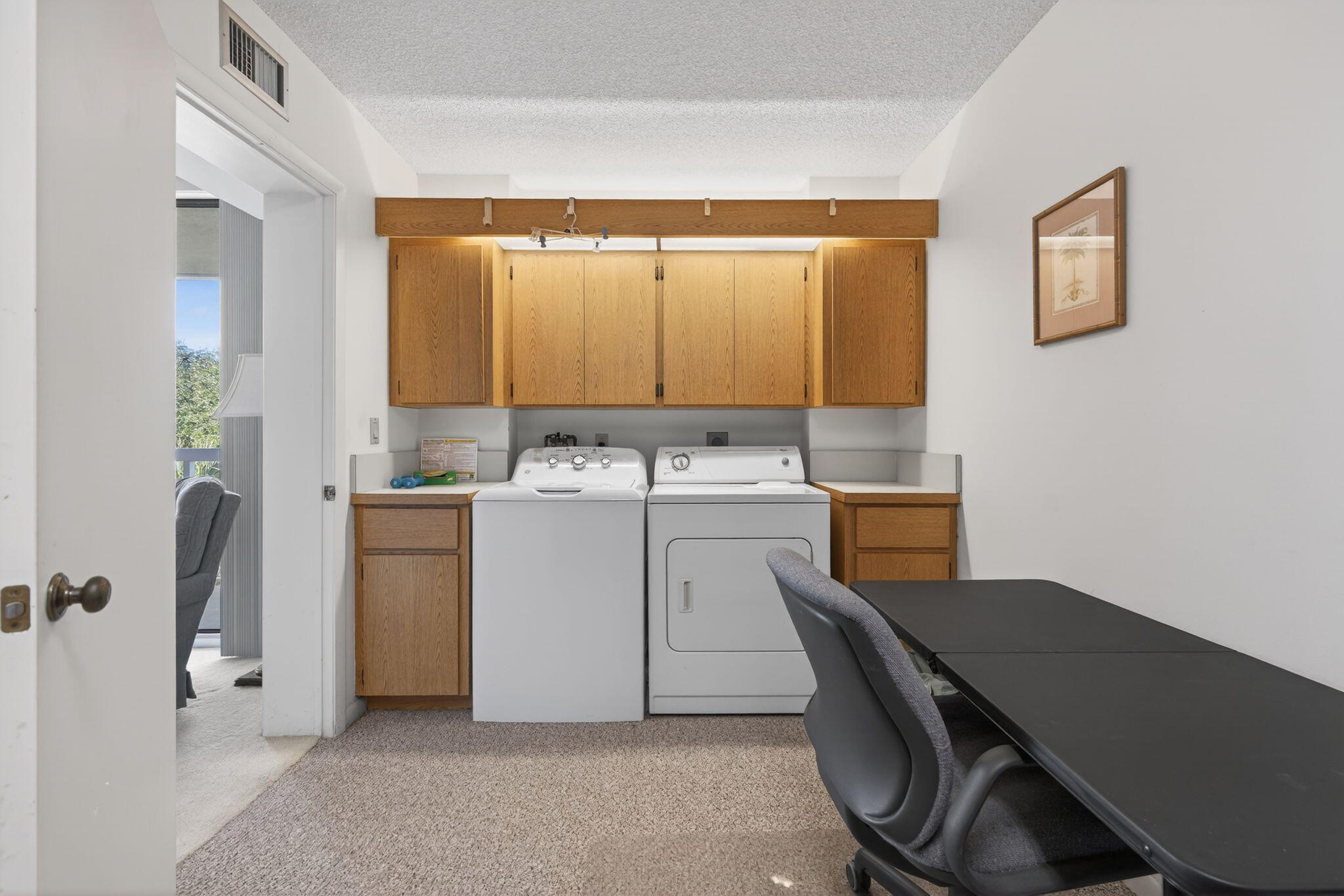 2581 Village Boulevard, Unit 401 West Palm Beach, FL 33409 - Photo 19 of 24 a utility room with cabinets washer and dryer