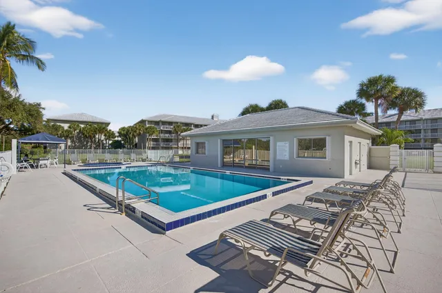 a view of a swimming pool with a lounge chairs