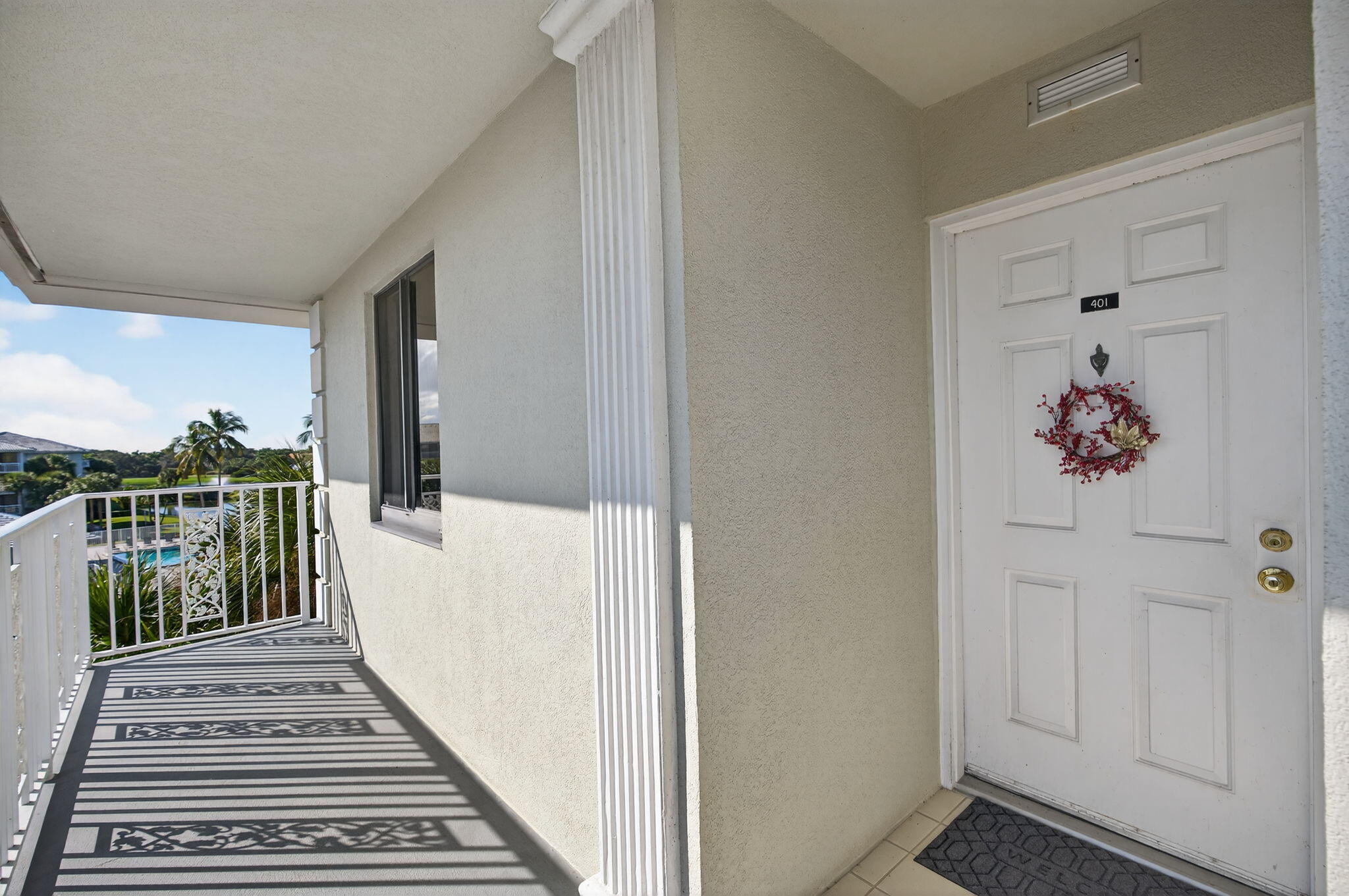 2581 Village Boulevard, Unit 401 West Palm Beach, FL 33409 - Photo 2 of 24 a view of a hallway with wooden floor and staircase