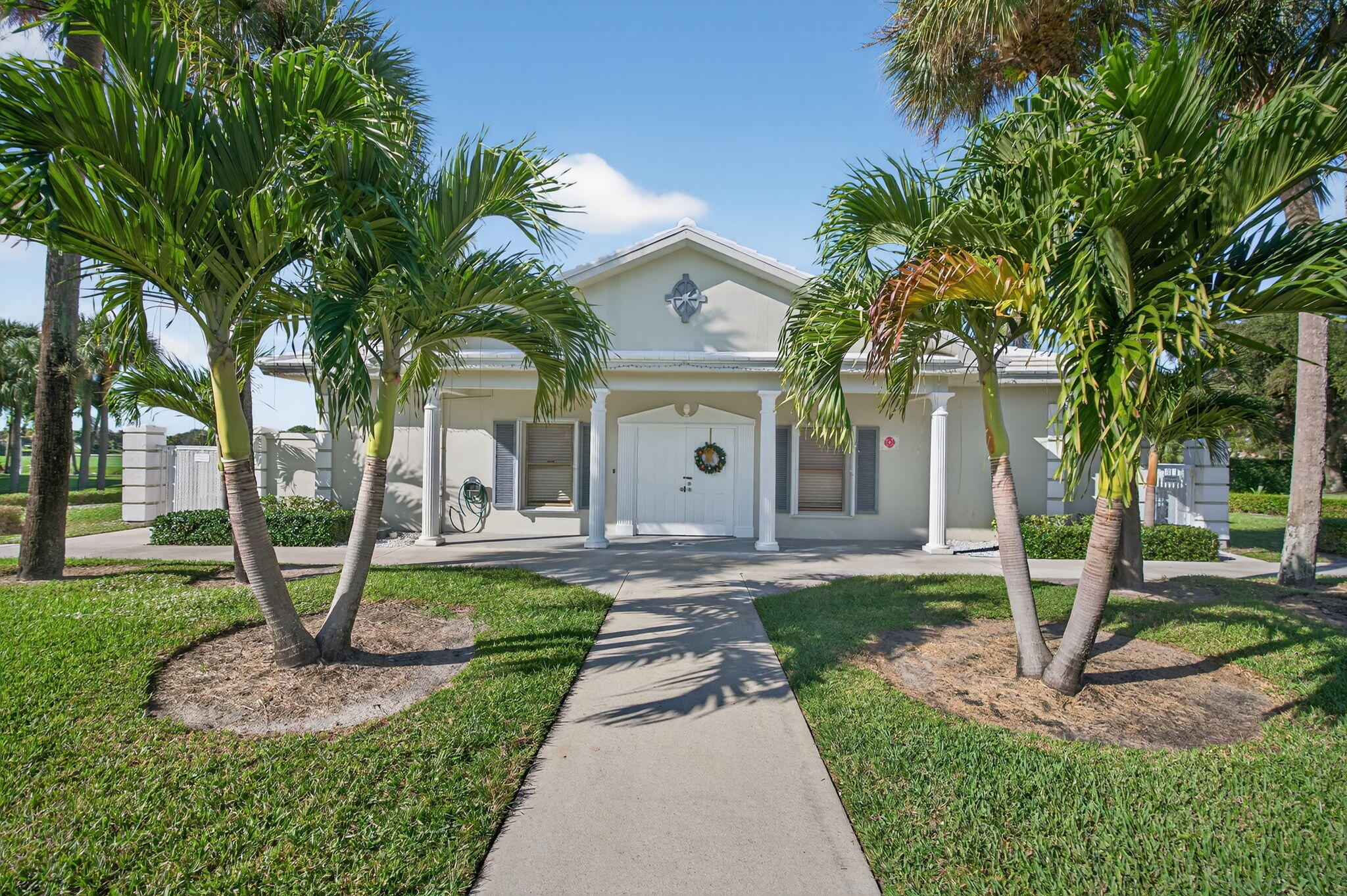 2581 Village Boulevard, Unit 401 West Palm Beach, FL 33409 - Photo 21 of 24 a front view of a house with garden