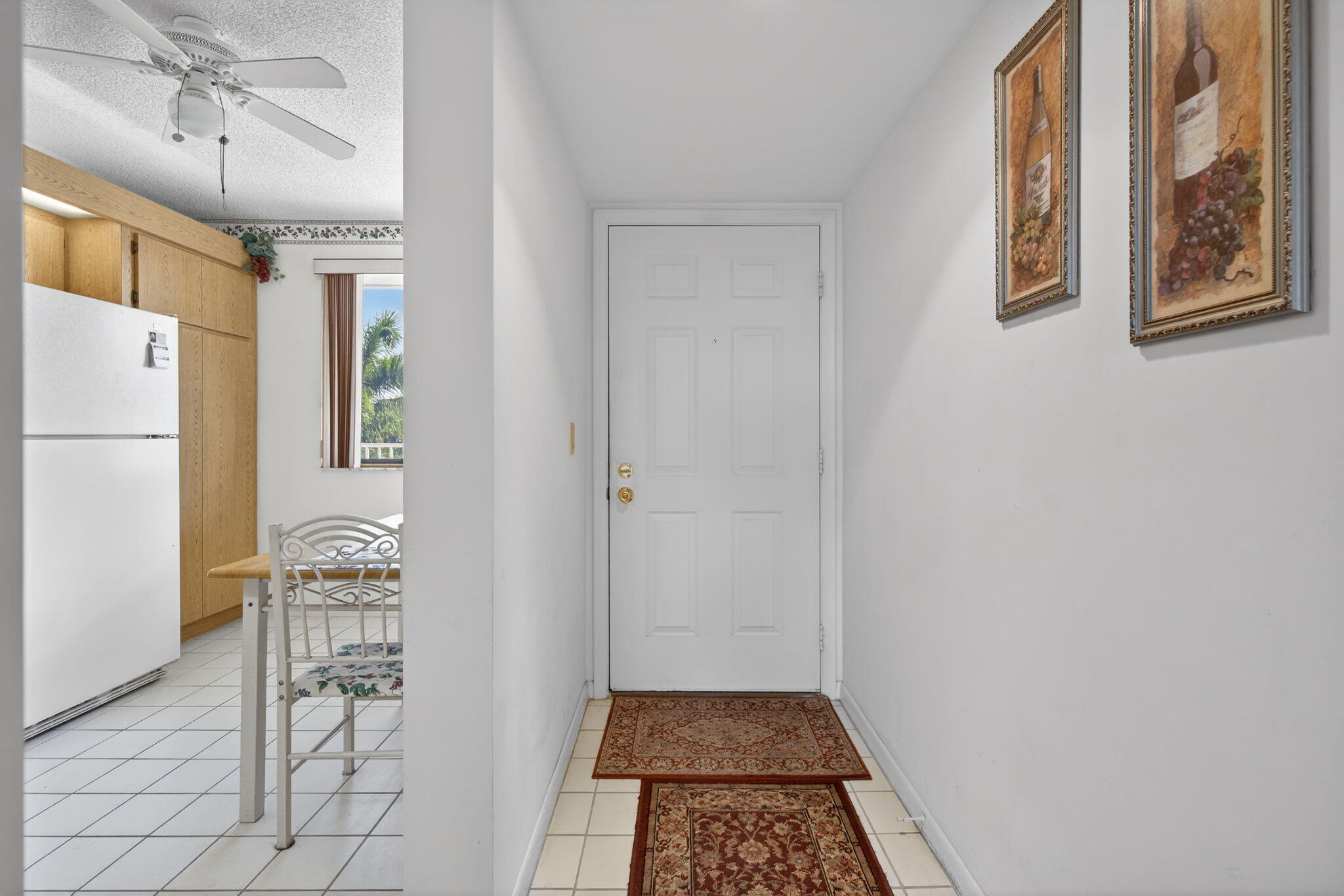 2581 Village Boulevard, Unit 401 West Palm Beach, FL 33409 - Photo 3 of 24 a hallway with dining area and glass doors