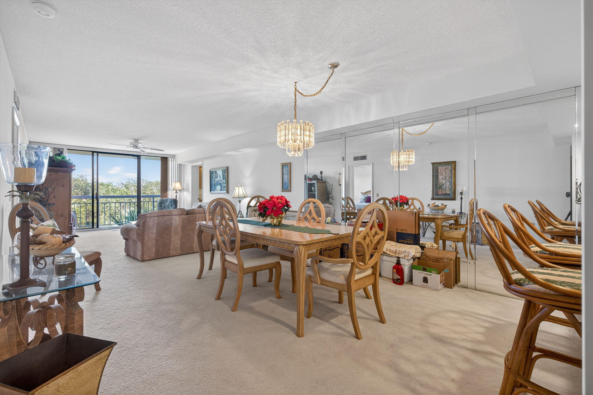 2581 Village Boulevard, Unit 401 West Palm Beach, FL 33409 - Photo 6 of 24 a living room with furniture a floor to ceiling window and a rug