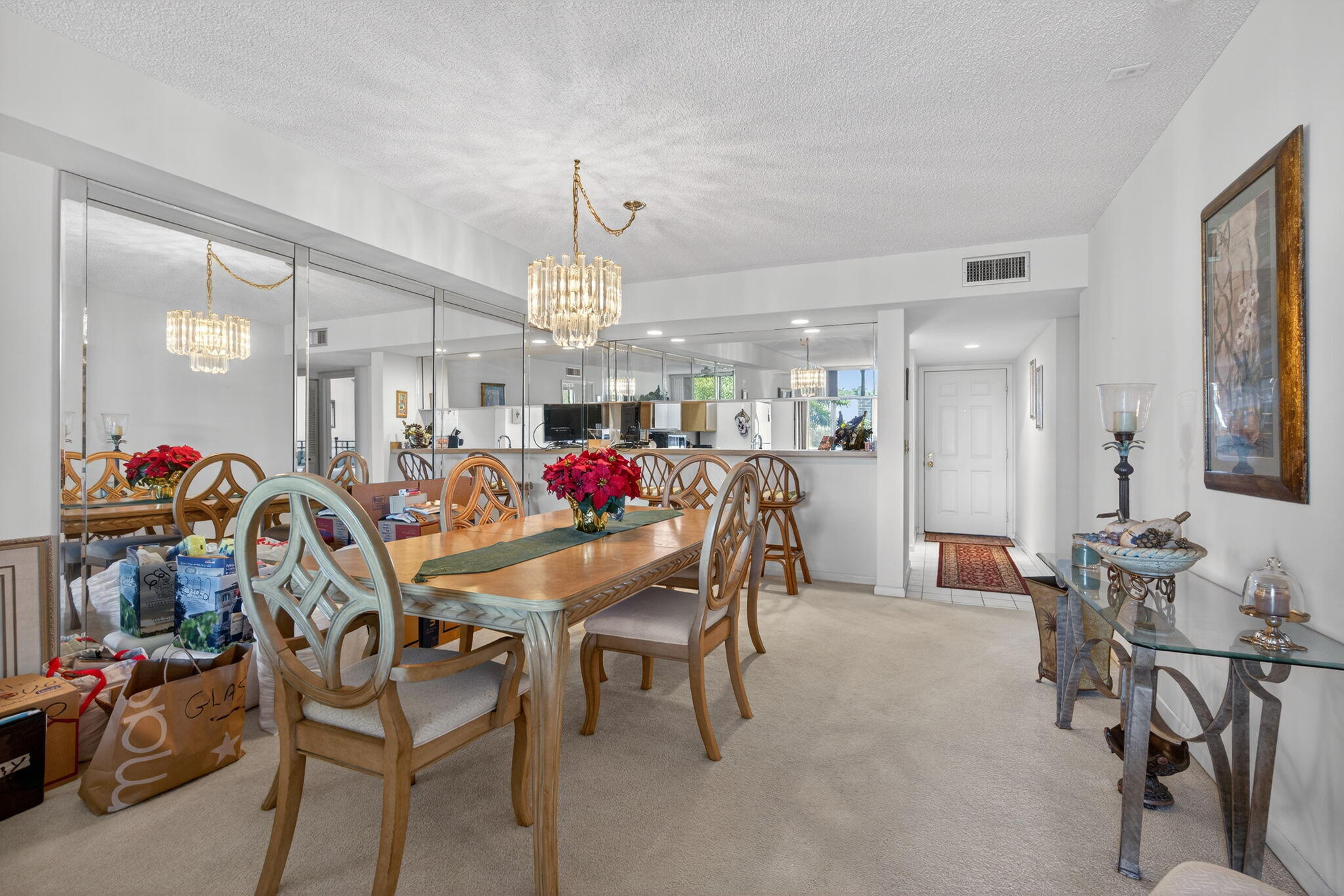2581 Village Boulevard, Unit 401 West Palm Beach, FL 33409 - Photo 7 of 24 a view of a dining room with furniture and a chandelier