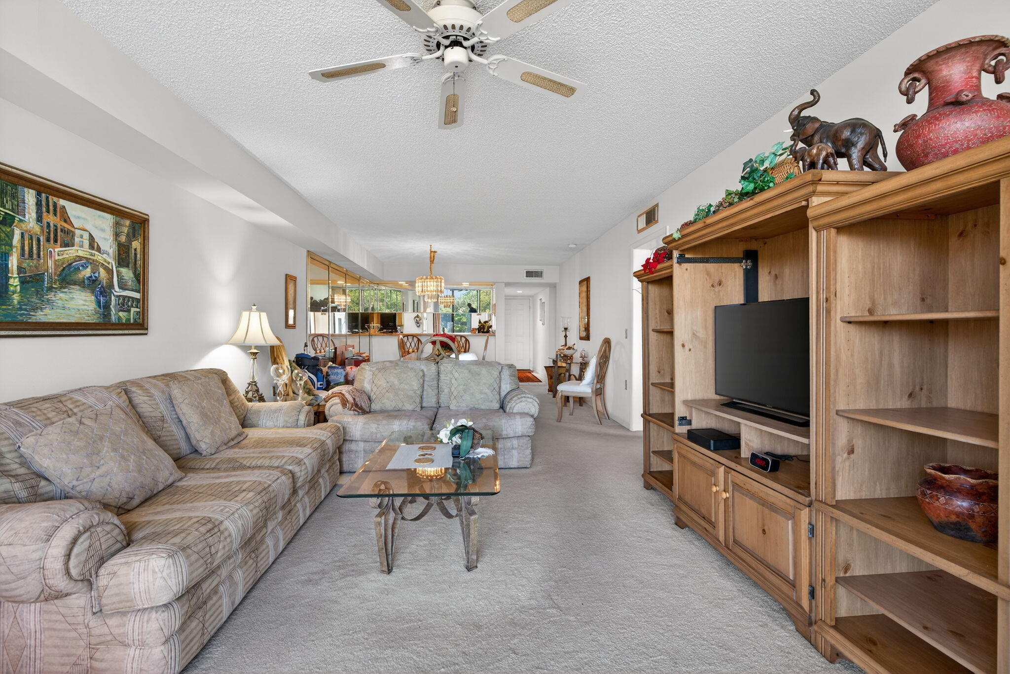 2581 Village Boulevard, Unit 401 West Palm Beach, FL 33409 - Photo 10 of 24 a living room with furniture and a flat screen tv