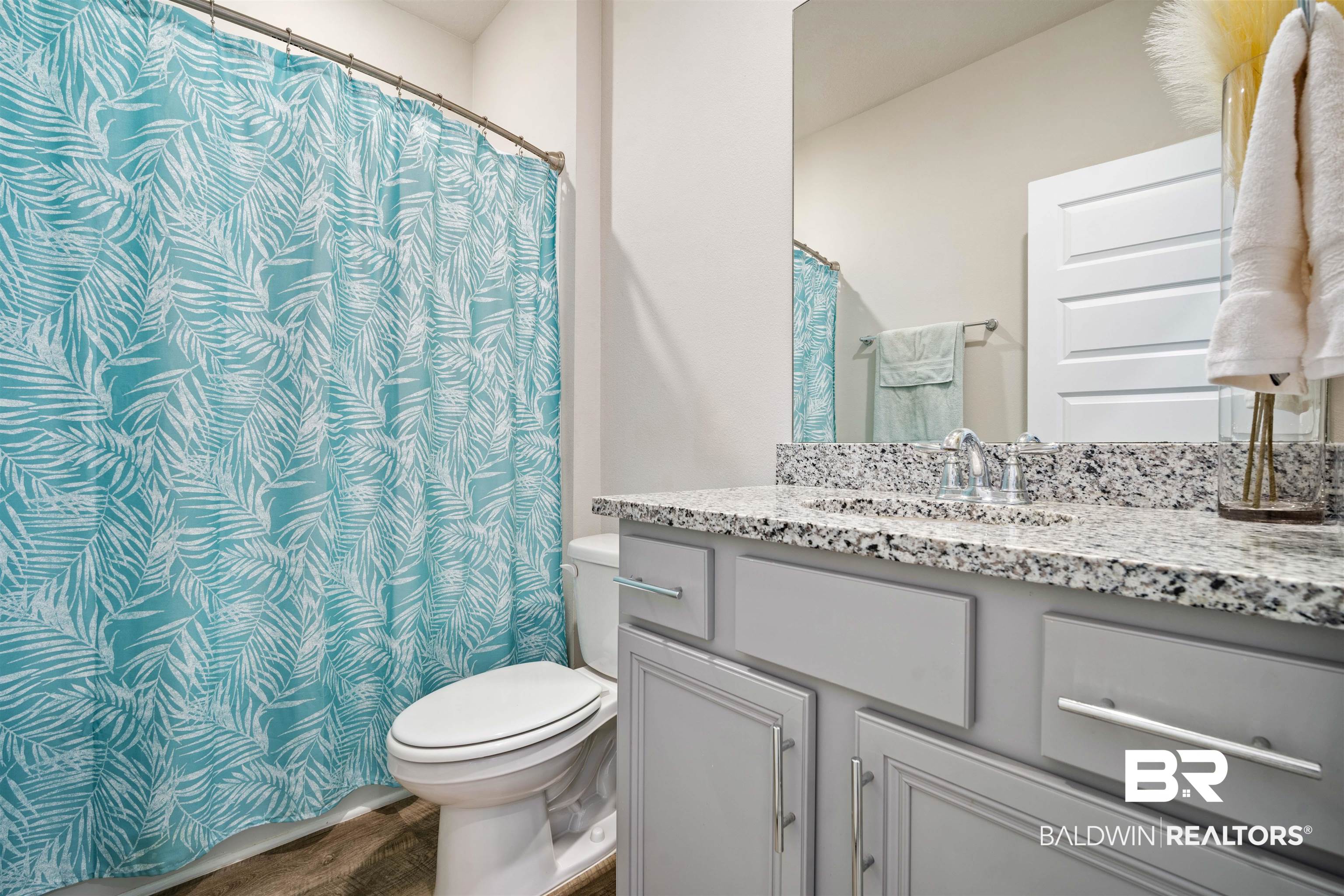 10474 Loamy Avenue Mobile, AL 36695 - Photo 22 of 31 Bathroom featuring vanity, curtained shower, and wood finished floors