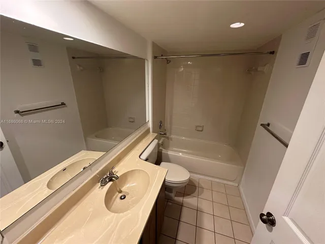 a bathroom with a tub a sink and a shower