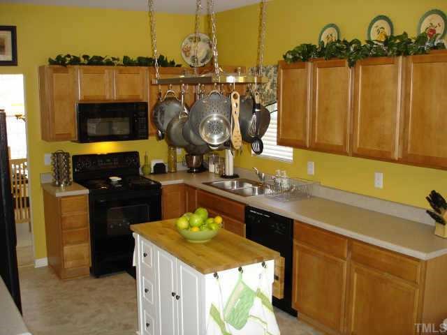5412 Glass Ridge Road Raleigh, NC 27616 - Photo 4 of 12 a kitchen with a sink and a stove