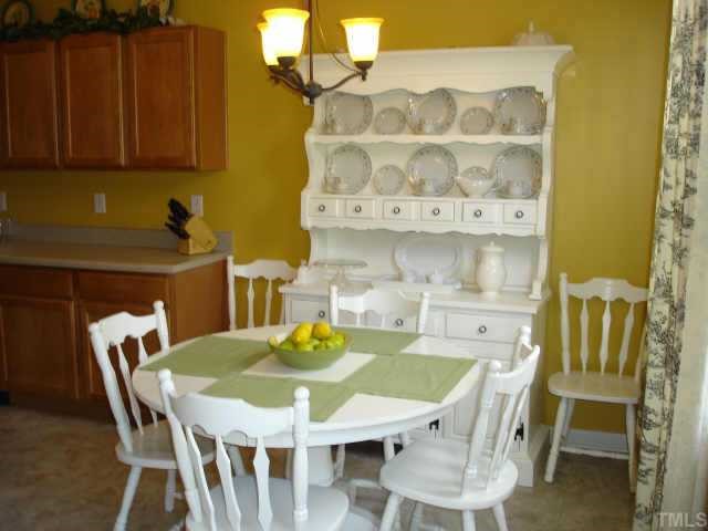 5412 Glass Ridge Road Raleigh, NC 27616 - Photo 5 of 12 a view of a dining room with furniture and wooden floor