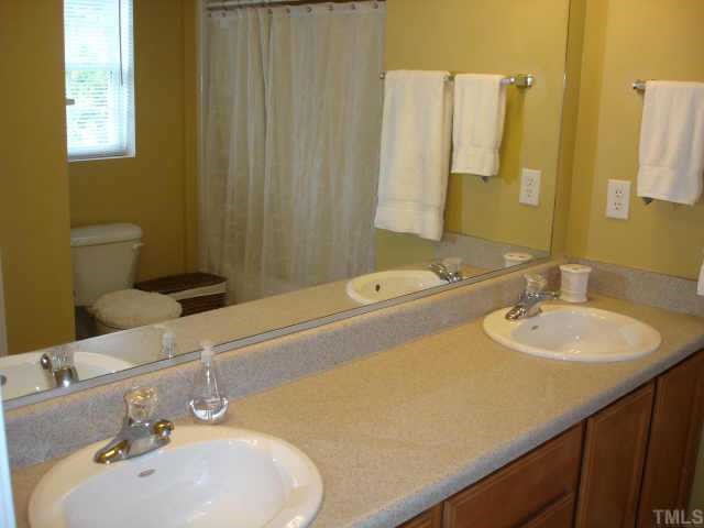 5412 Glass Ridge Road Raleigh, NC 27616 - Photo 8 of 12 a bathroom with a sink and a mirror