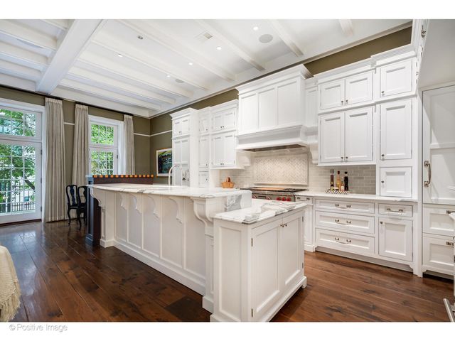 a living room with furniture and large windows
