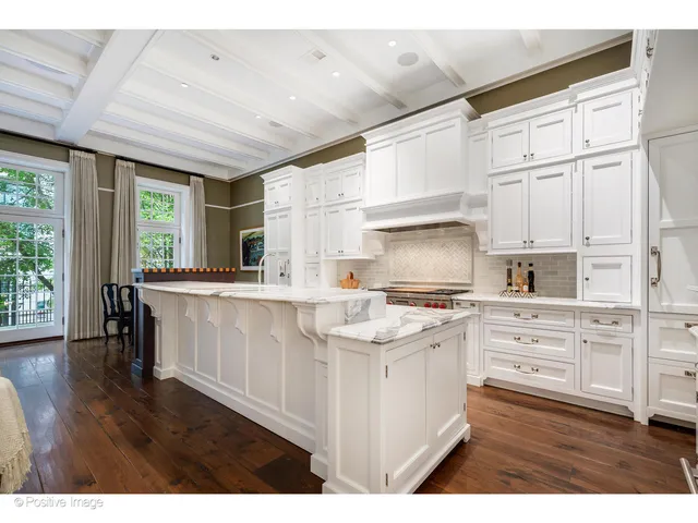 a living room with fireplace furniture and a large window
