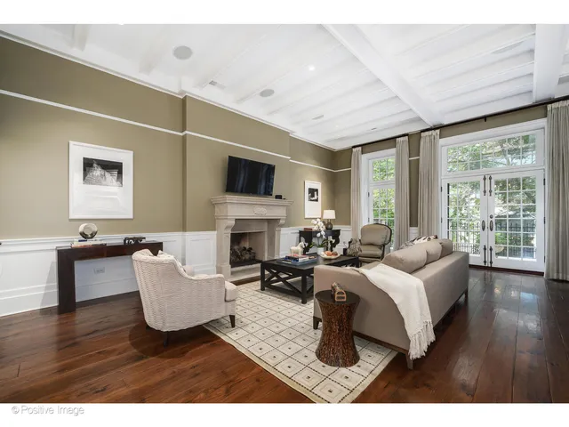 a view of a dining room with furniture a chandelier and wooden floor