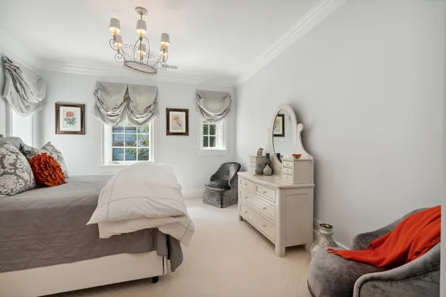 a living room with furniture a flat screen tv and a window
