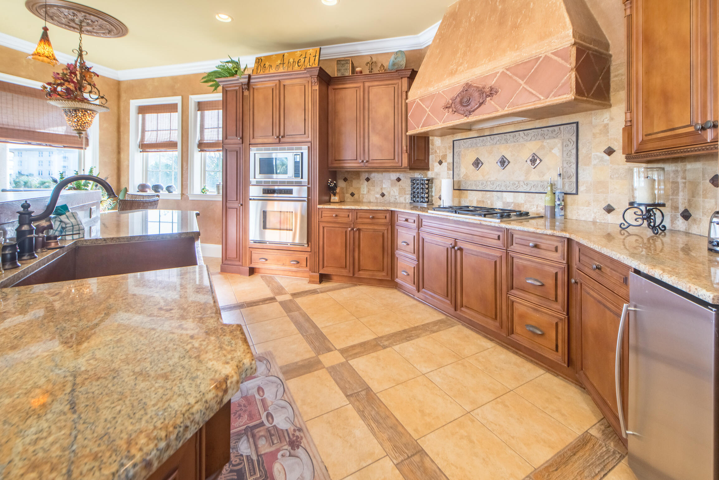 59 St Tropez Court Miramar Beach, FL 32550 - Photo 11 of 37 a large kitchen with kitchen island granite countertop a large counter top stainless steel appliances and cabinets