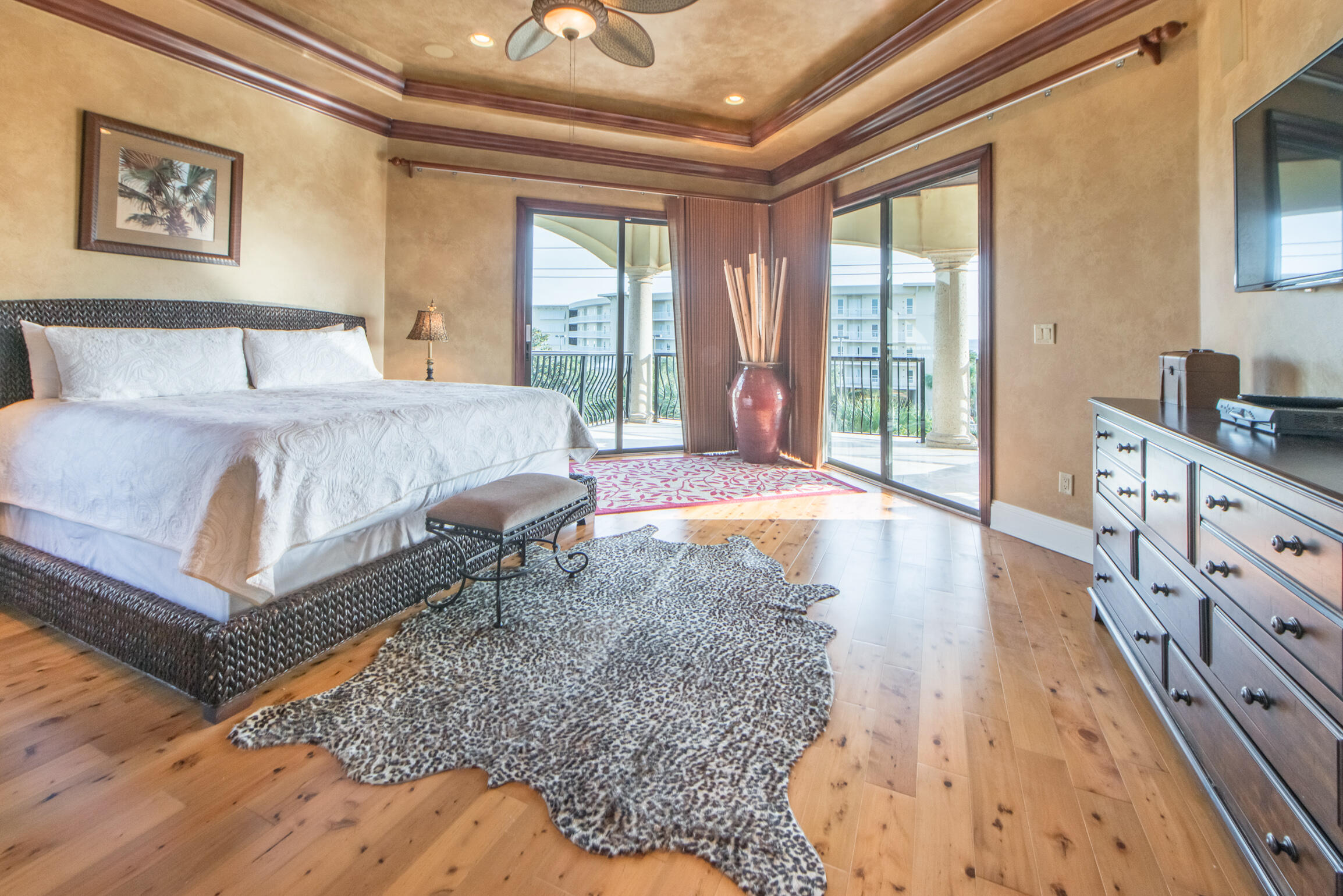 59 St Tropez Court Miramar Beach, FL 32550 - Photo 19 of 37 a spacious bedroom with a bed a table and painting on the wall
