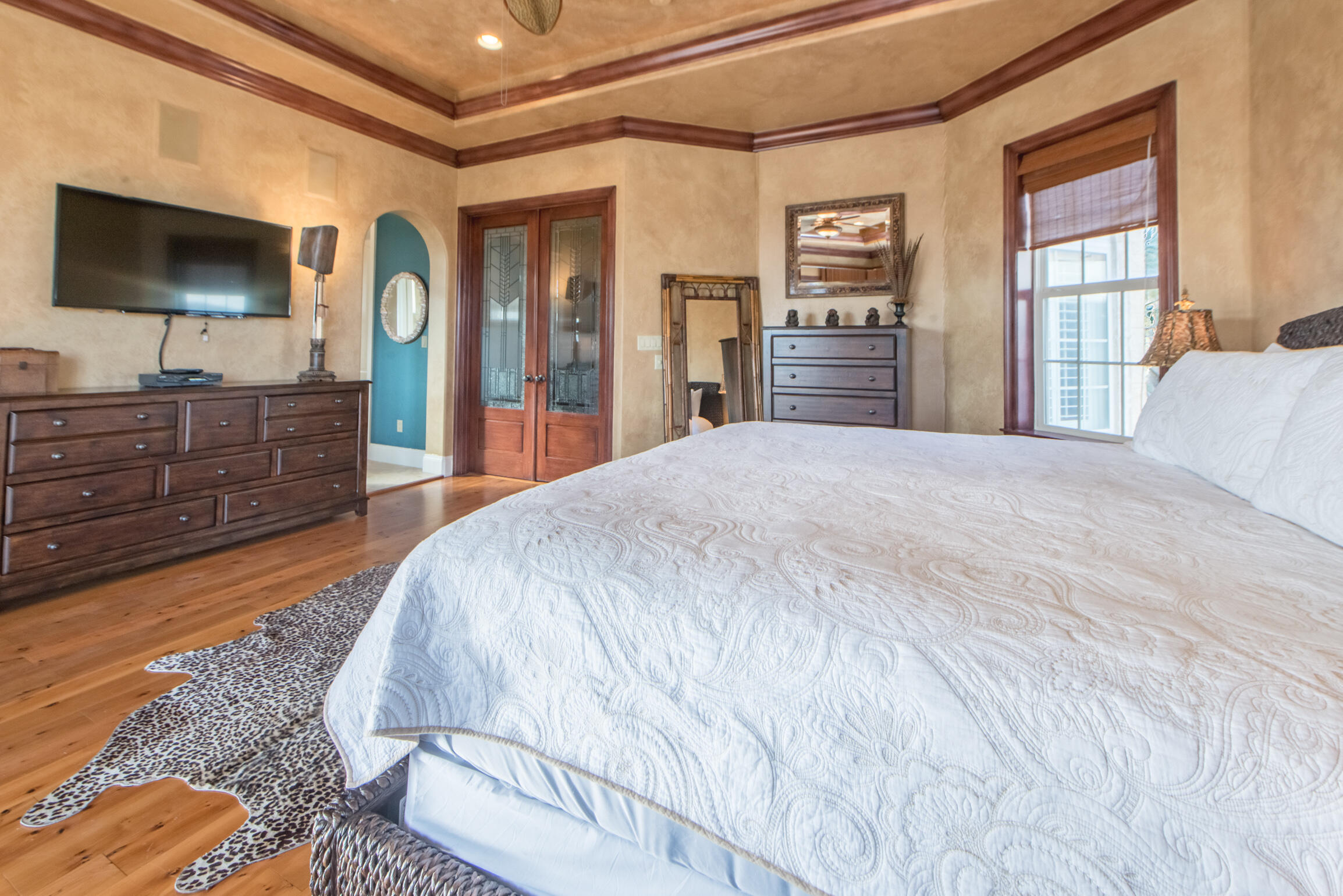 59 St Tropez Court Miramar Beach, FL 32550 - Photo 20 of 37 a spacious bedroom with a bed and a flat screen tv