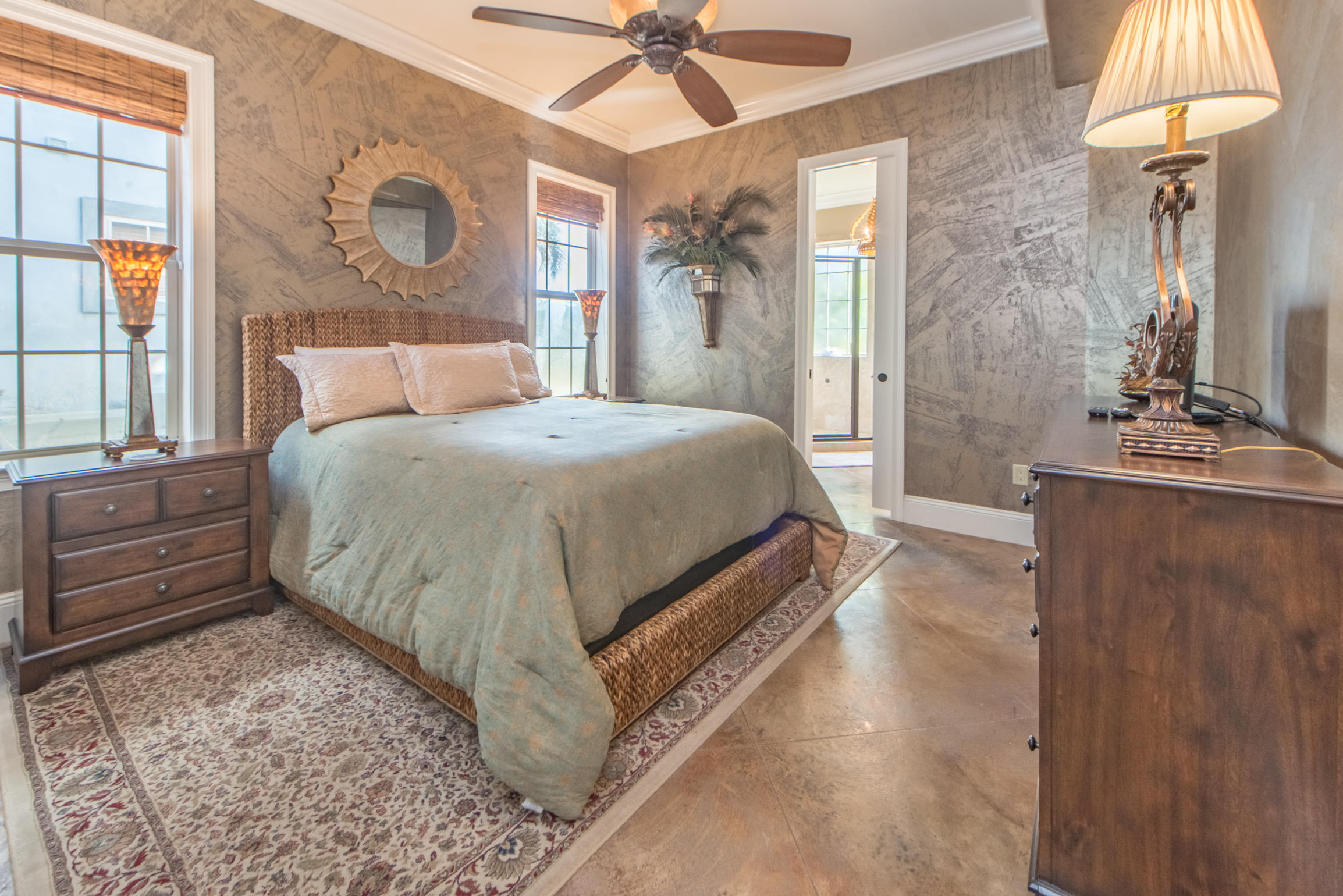 59 St Tropez Court Miramar Beach, FL 32550 - Photo 29 of 37 a bedroom with a bed and a chandelier