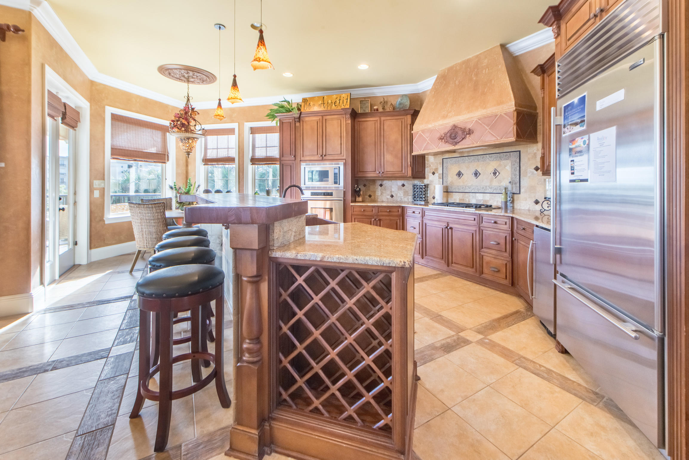 59 St Tropez Court Miramar Beach, FL 32550 - Photo 9 of 37 a dining hall with stainless steel appliances kitchen island granite countertop a table and chairs