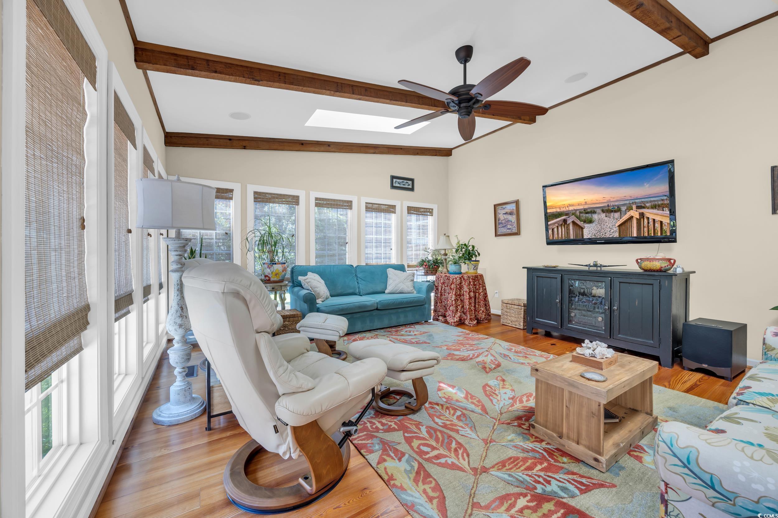 855 Riven Oak Drive Murrells Inlet, SC 29576 - Photo 13 of 37 Living room featuring wood finished floors, a skylight, and ceiling fan