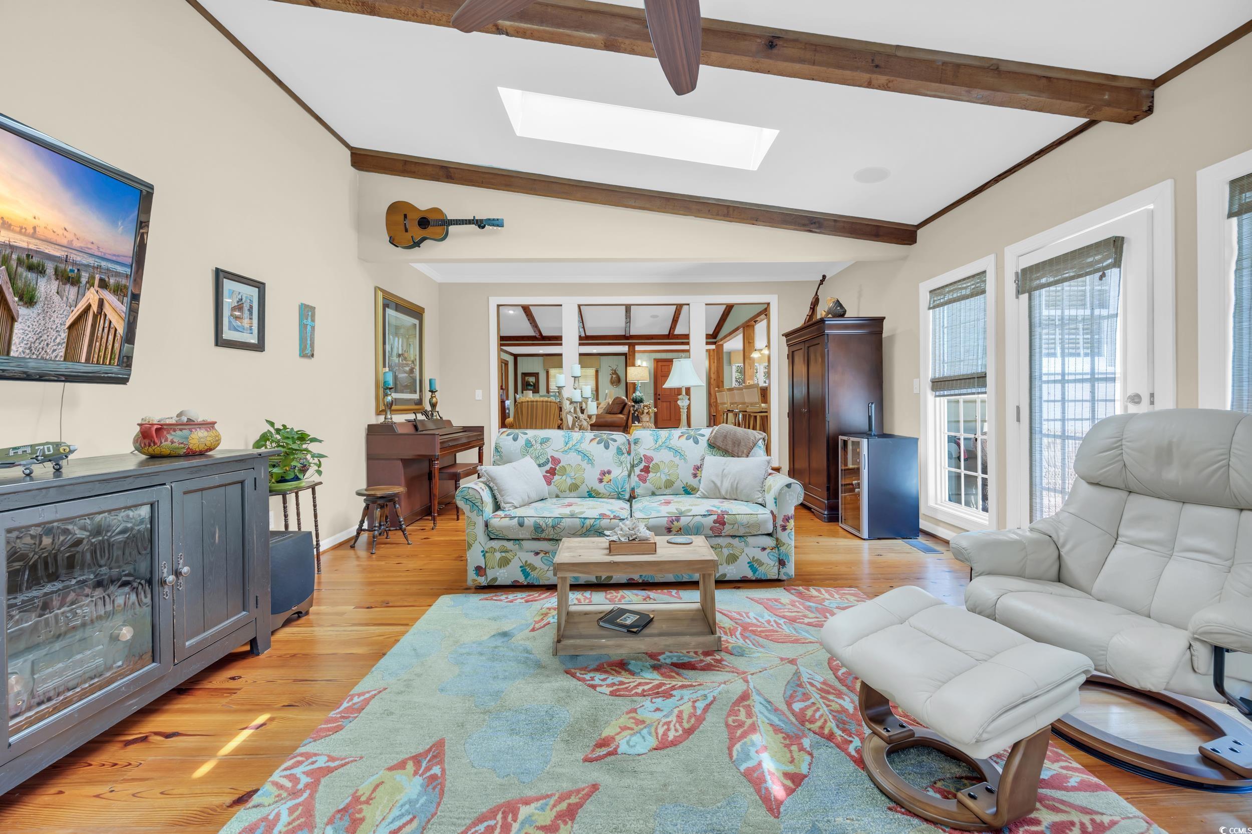 855 Riven Oak Drive Murrells Inlet, SC 29576 - Photo 14 of 37 Living area featuring light wood-style floors, a skylight, and ornamental molding