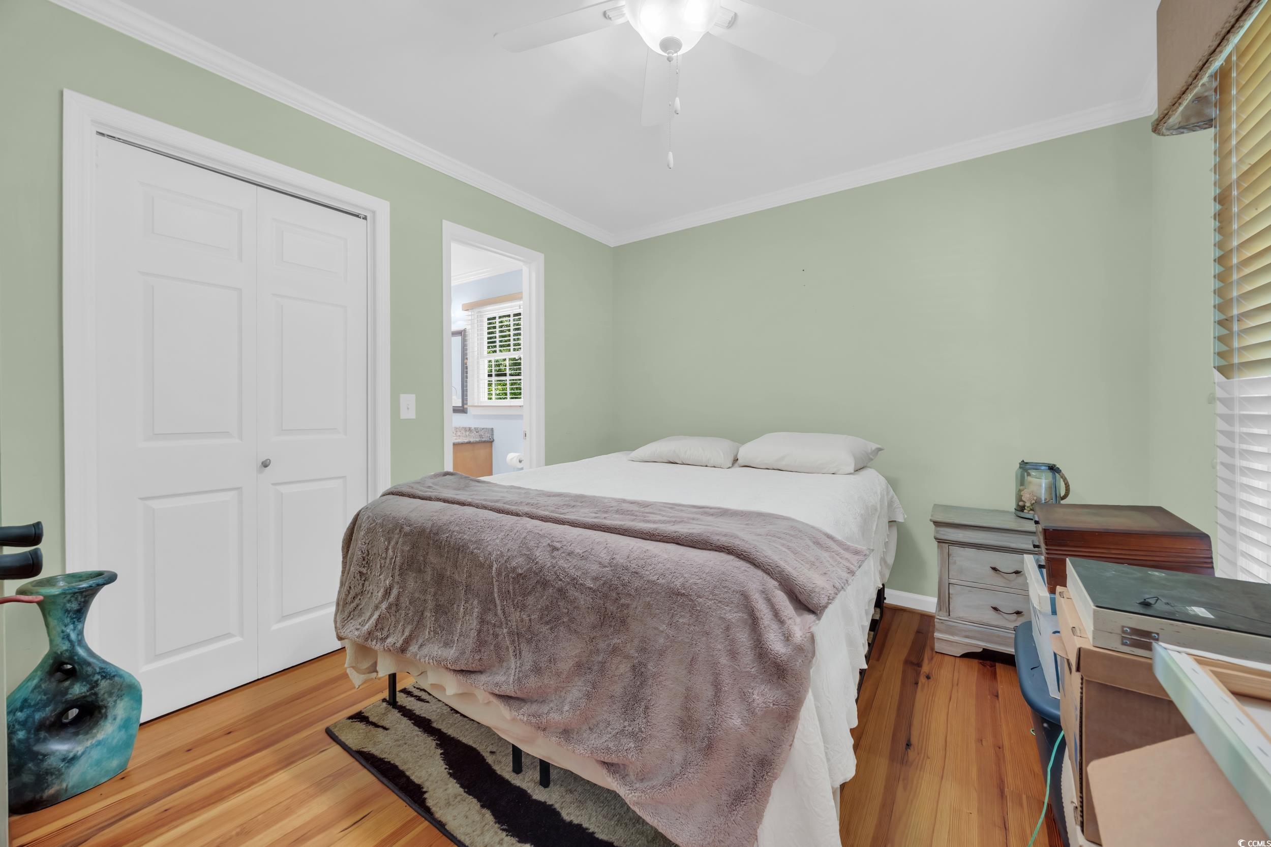 855 Riven Oak Drive Murrells Inlet, SC 29576 - Photo 18 of 37 Bedroom featuring light wood-style floors, a closet, ornamental molding, and ceiling fan