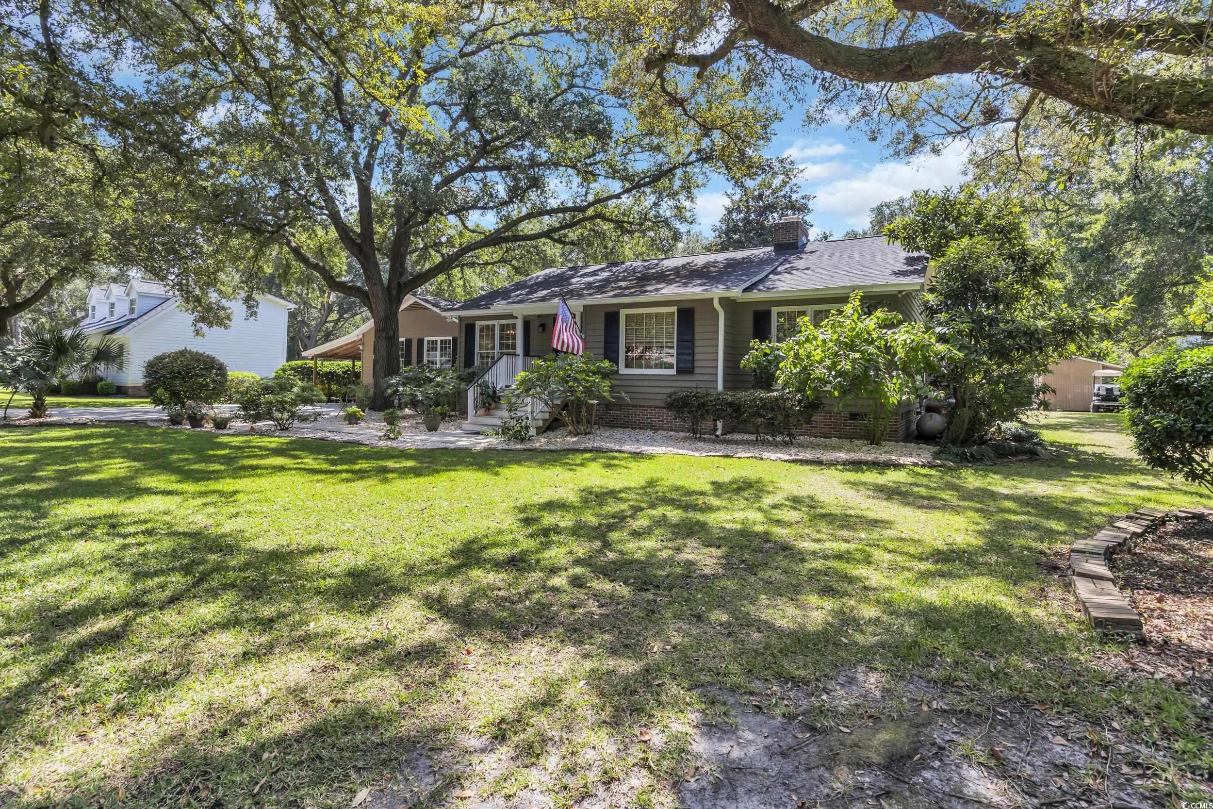 855 Riven Oak Drive Murrells Inlet, SC 29576 - Photo 2 of 37 View of front of home with a chimney, a front lawn, and crawl space