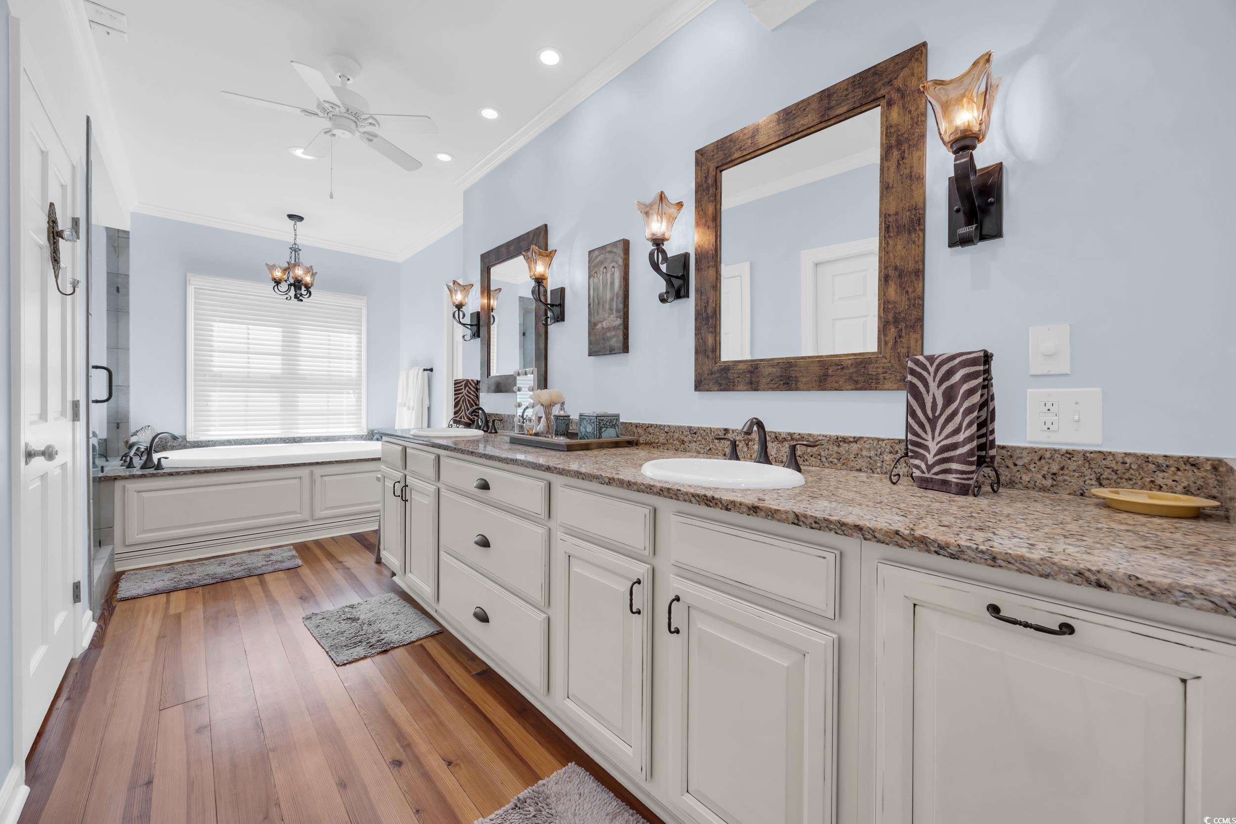 855 Riven Oak Drive Murrells Inlet, SC 29576 - Photo 21 of 37 Full bath with crown molding, double vanity, a bath, light wood-type flooring, and a ceiling fan