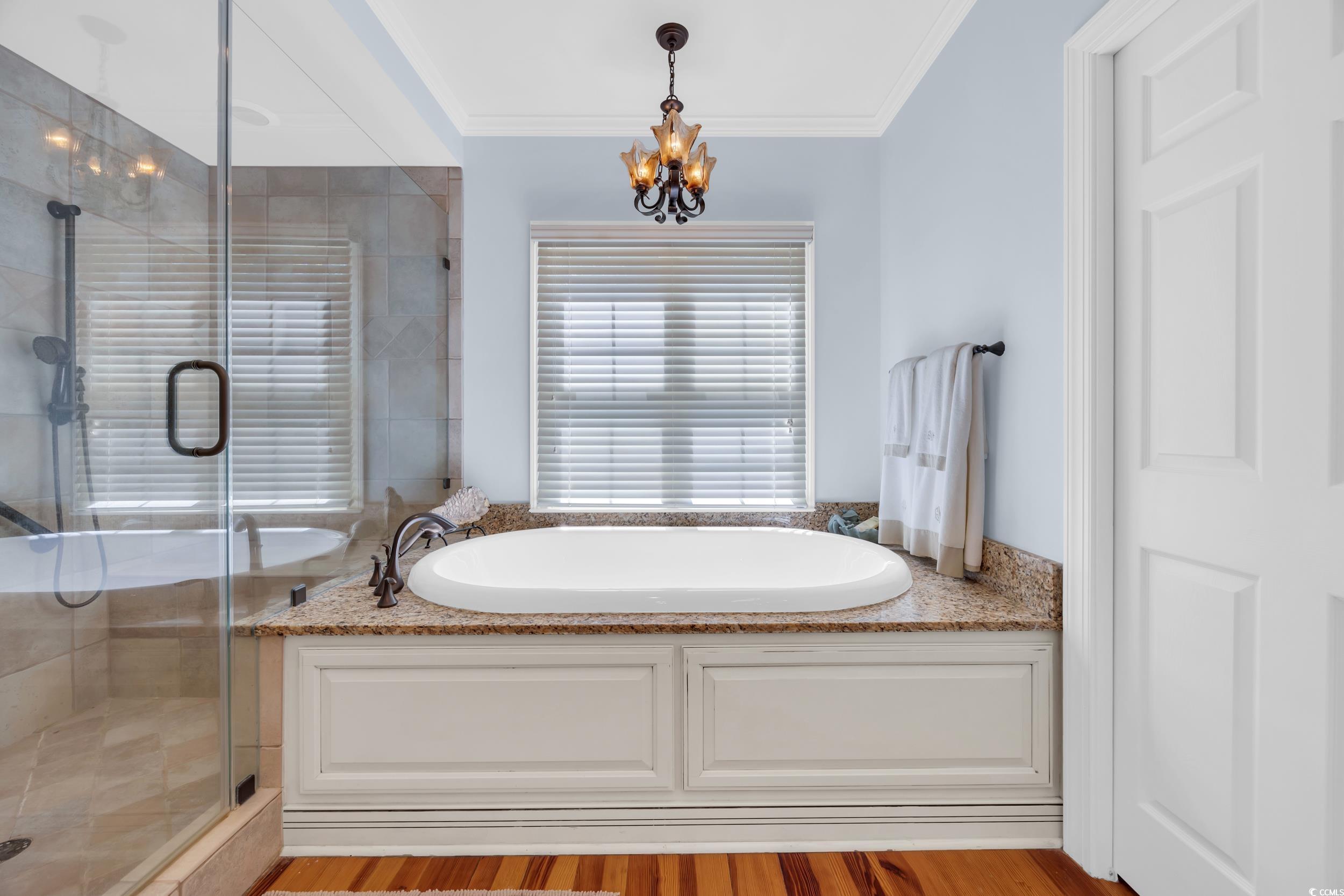 855 Riven Oak Drive Murrells Inlet, SC 29576 - Photo 23 of 37 Full bath with a garden tub, a stall shower, crown molding, light wood-style floors, and a chandelier