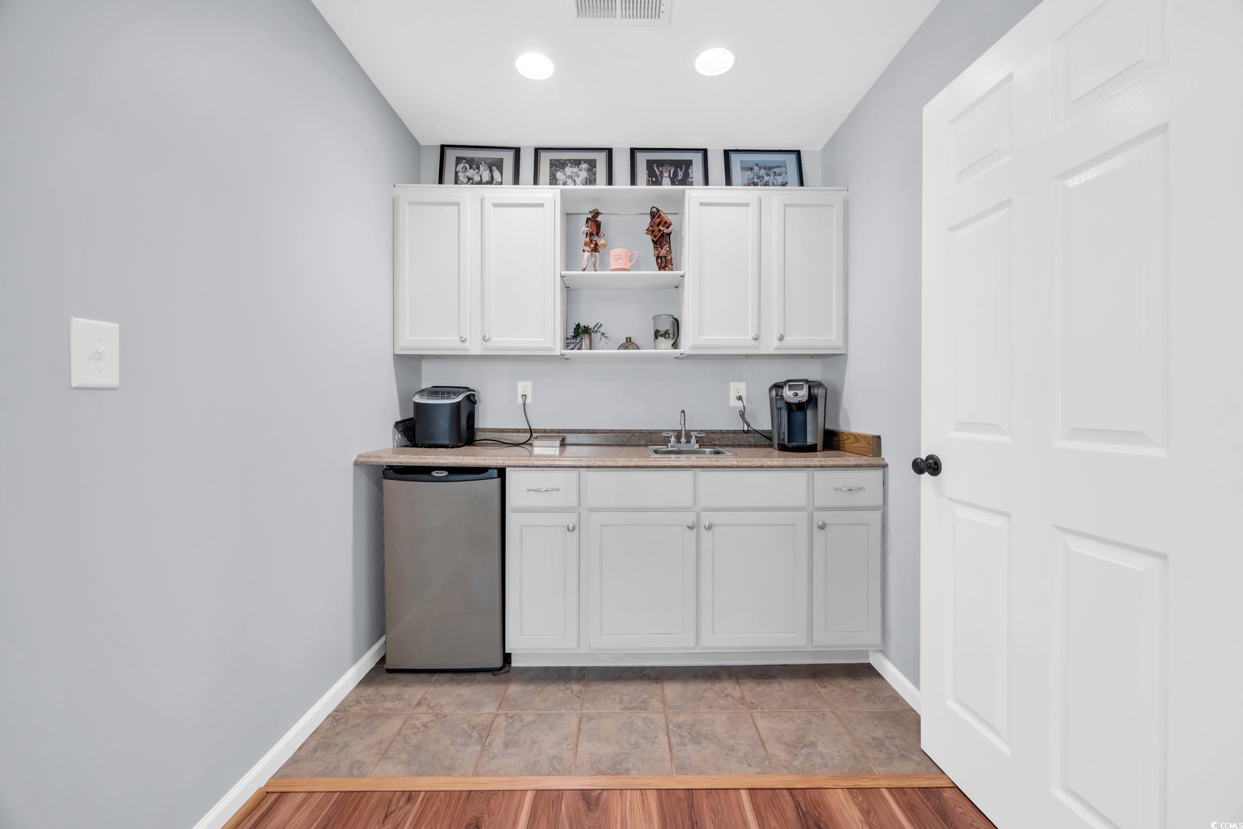 855 Riven Oak Drive Murrells Inlet, SC 29576 - Photo 25 of 37 Indoor wet bar featuring white cabinetry, stainless steel refrigerator, open shelves, light wood-style flooring, and recessed lighting