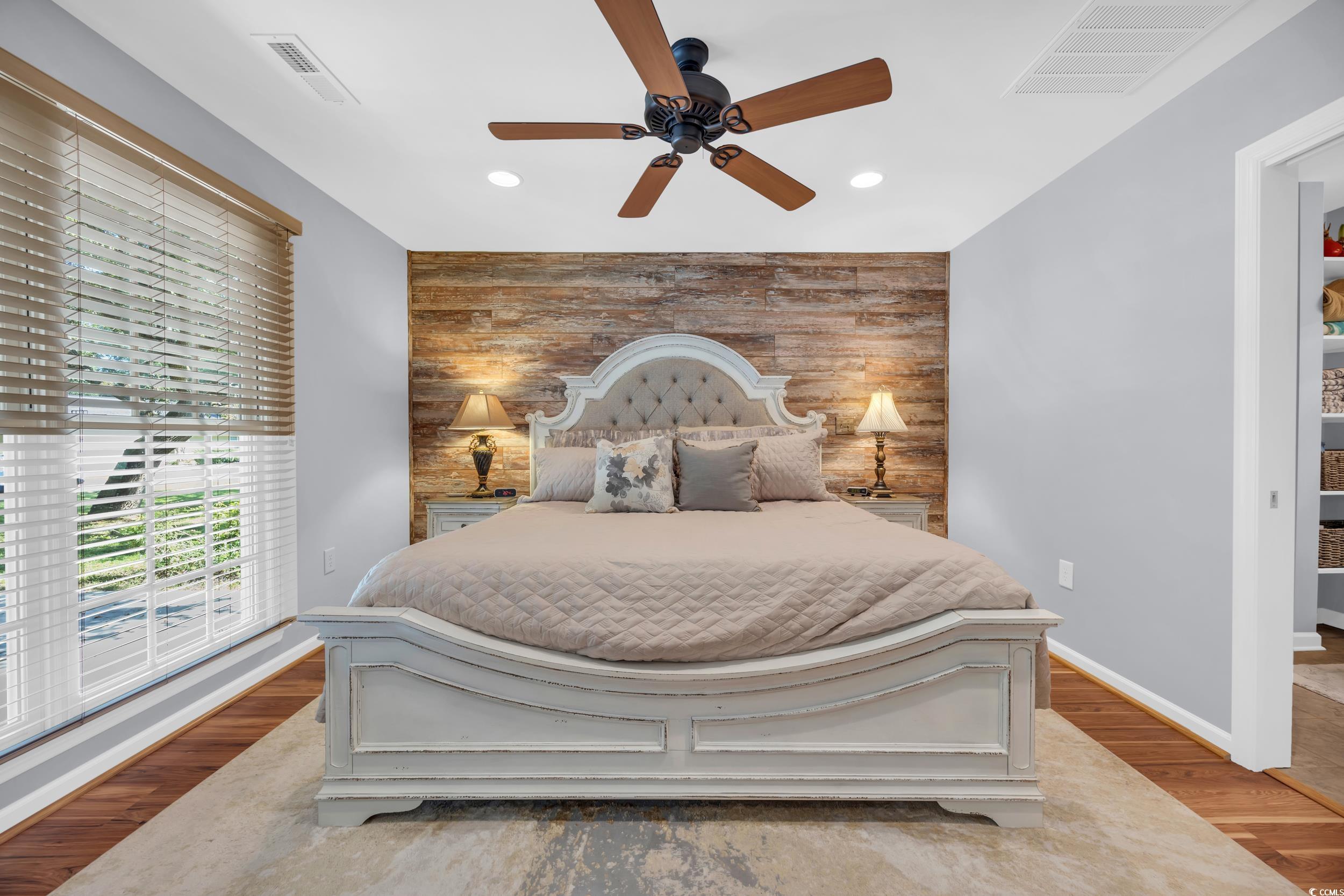 855 Riven Oak Drive Murrells Inlet, SC 29576 - Photo 26 of 37 Bedroom with an accent wall, wood finished floors, ceiling fan, access to outside, and recessed lighting