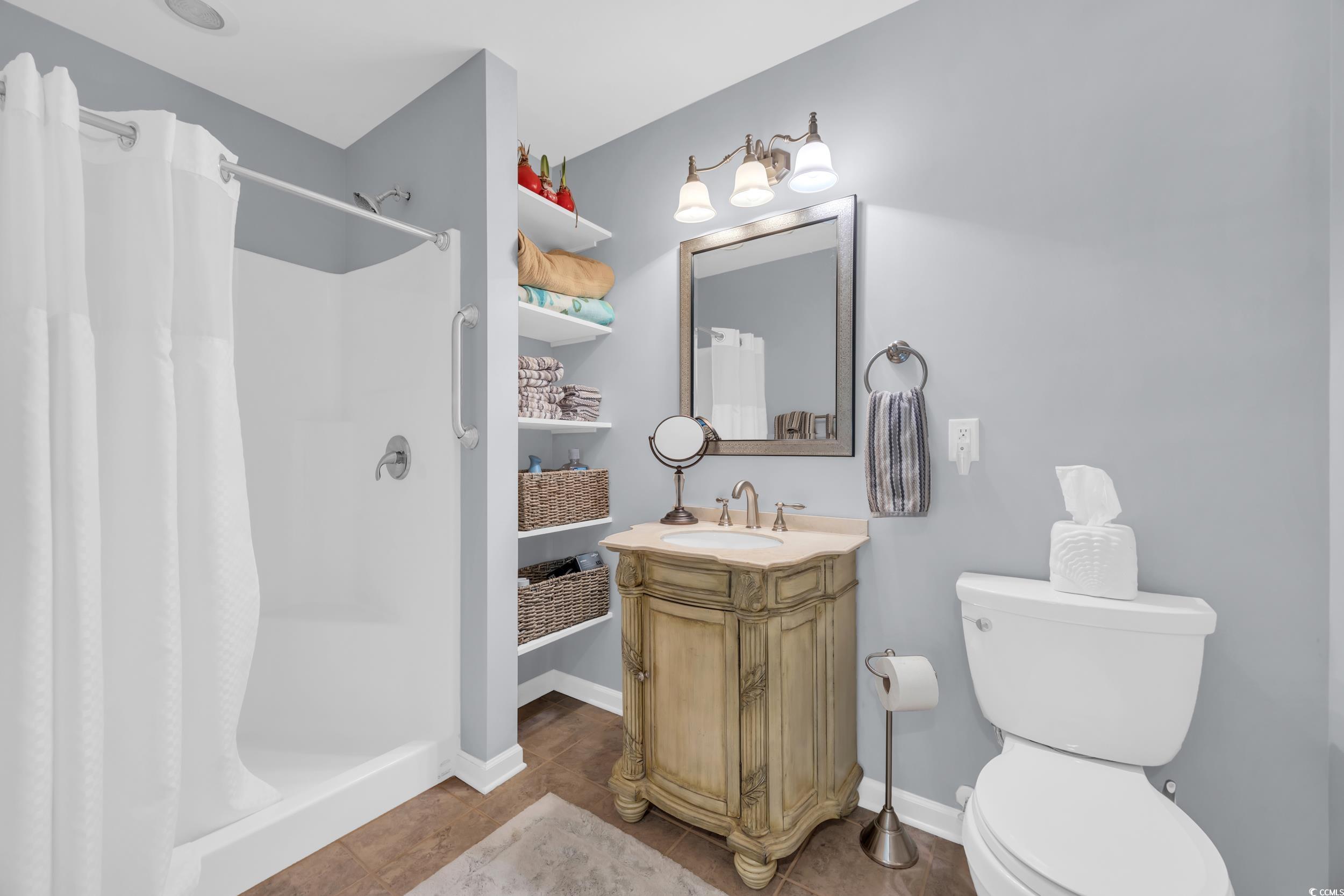 855 Riven Oak Drive Murrells Inlet, SC 29576 - Photo 27 of 37 Full bath featuring a stall shower, vanity, and tile patterned flooring