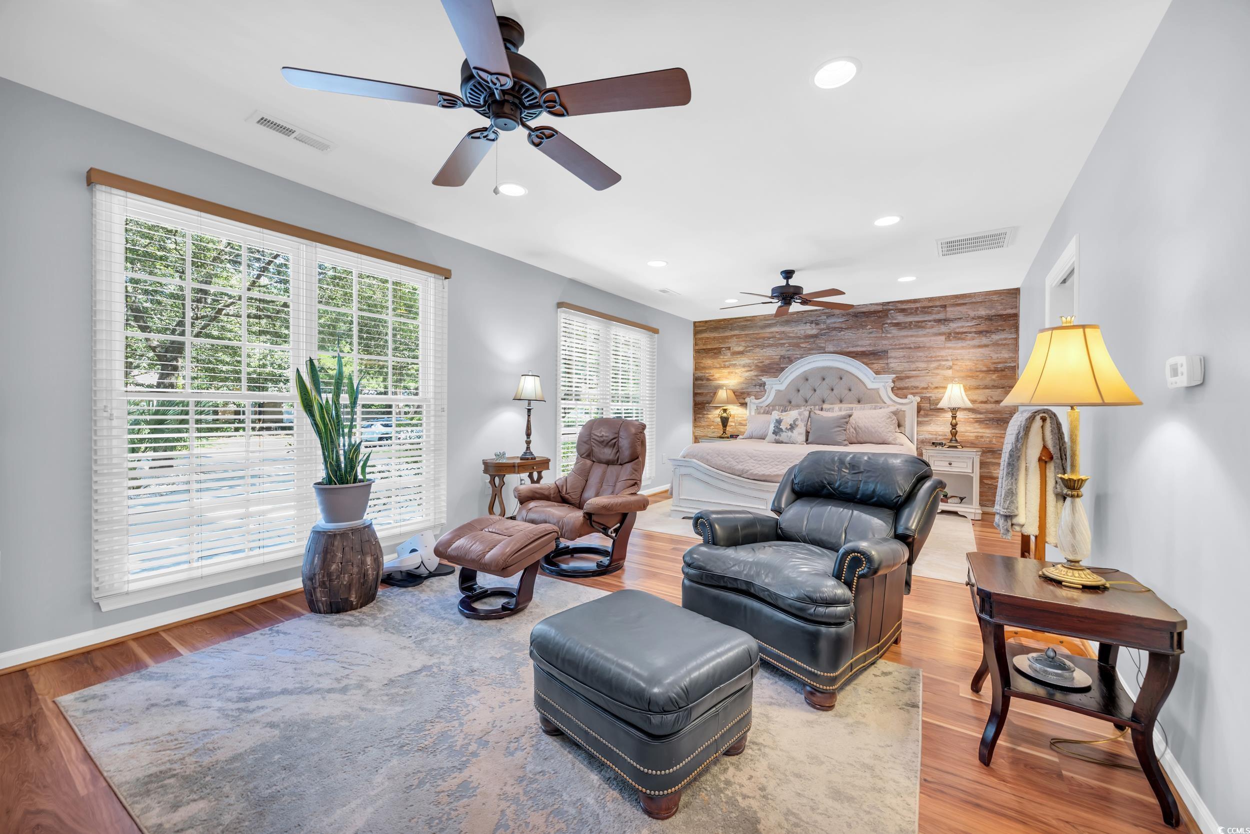 855 Riven Oak Drive Murrells Inlet, SC 29576 - Photo 28 of 37 Bedroom with light wood-type flooring, recessed lighting, wood walls, ceiling fan, and an accent wall