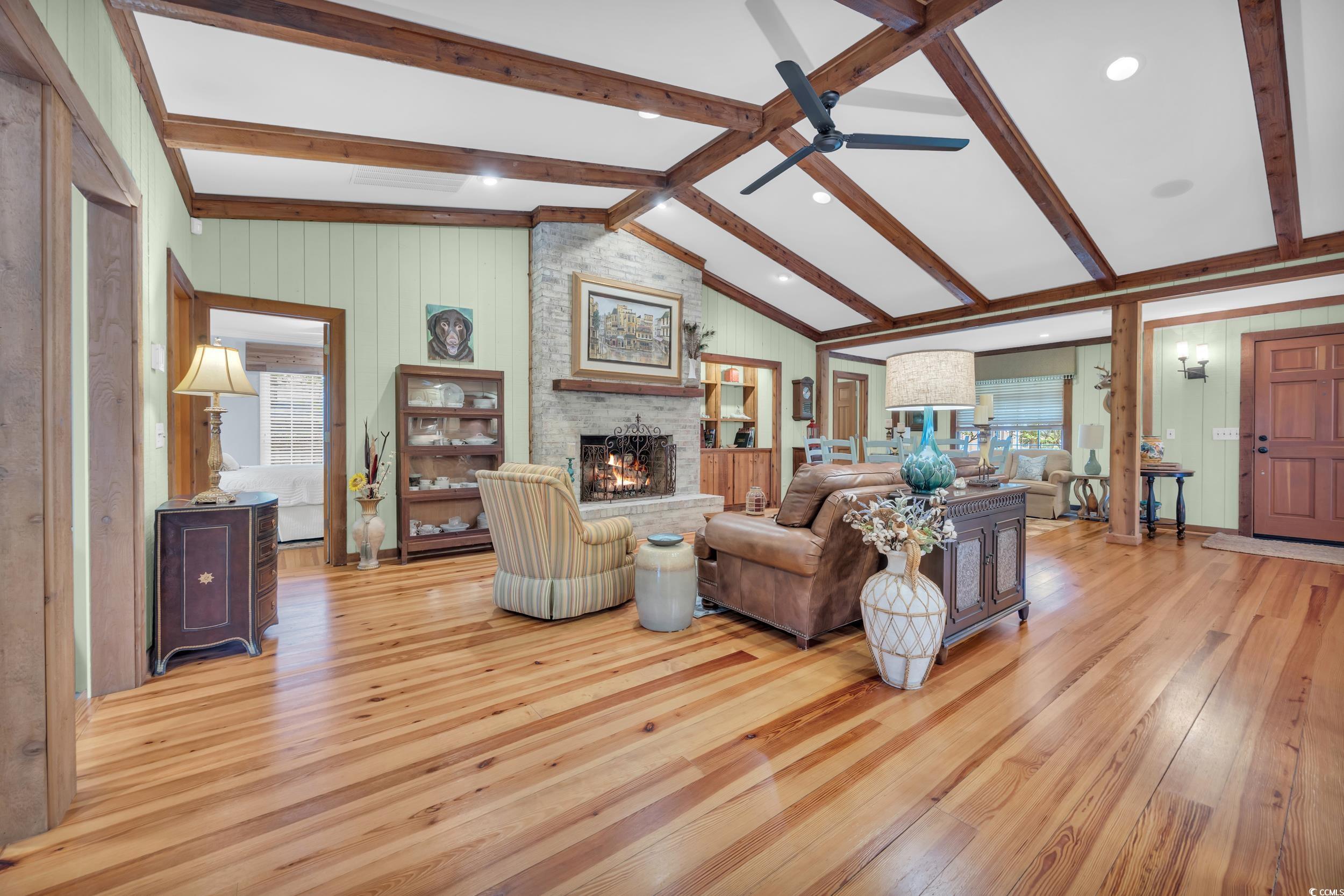 855 Riven Oak Drive Murrells Inlet, SC 29576 - Photo 7 of 37 Living area with a large fireplace, light wood finished floors, and wooden walls