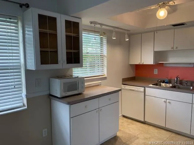 a kitchen with granite countertop cabinets and appliances