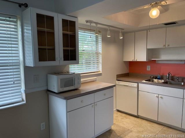 2929 Southeast Ocean Boulevard, Unit 10810 Stuart, FL 34996 - Photo 9 of 24 a kitchen with granite countertop white cabinets and window