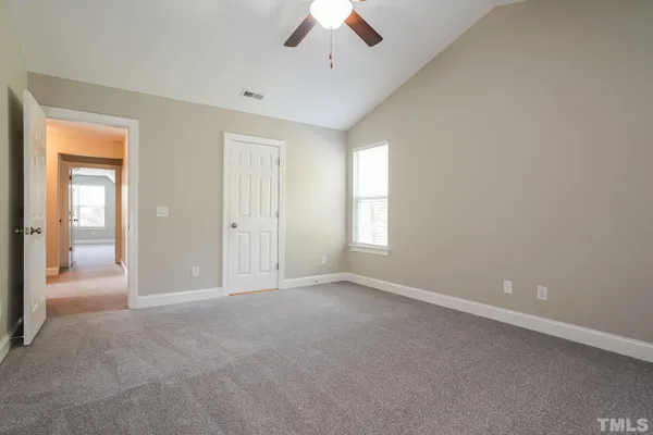 an empty room with a empty space and windows