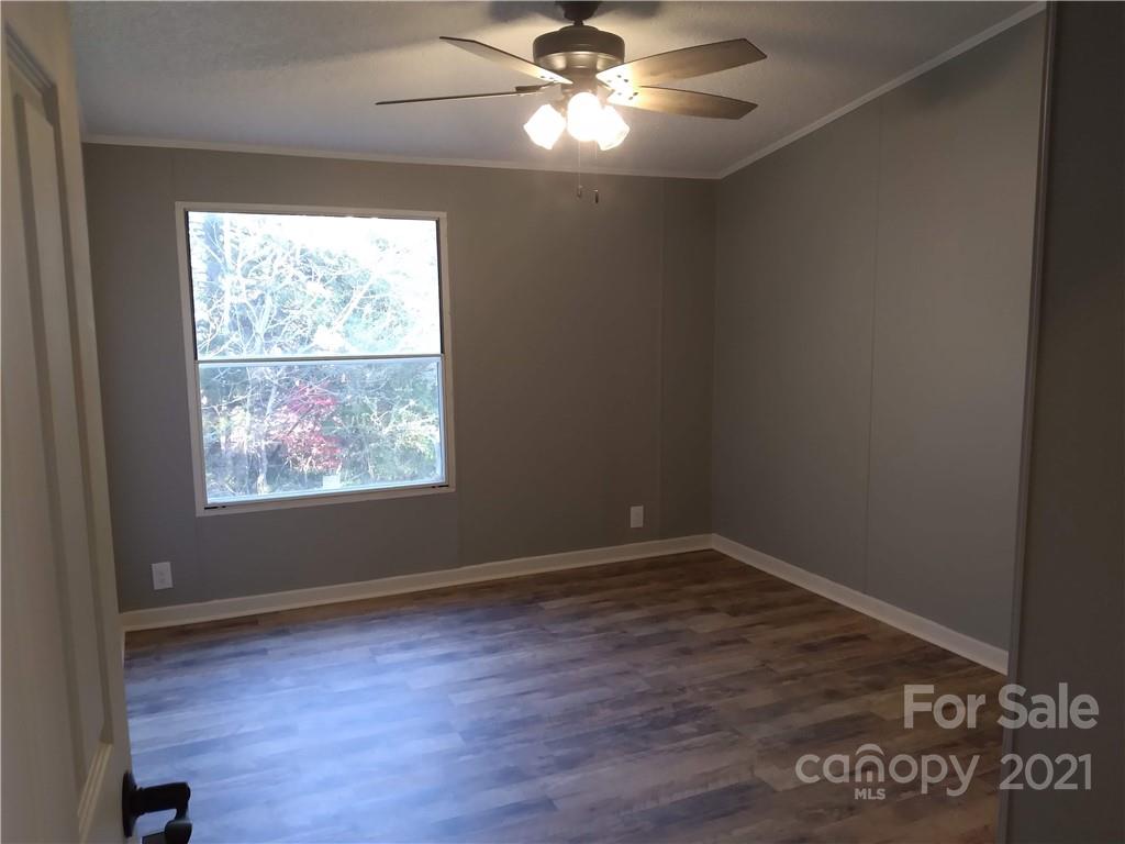 245 Roy Goins Road Rutherfordton, NC 28139 - Photo 12 of 23 an empty room with wooden floor and windows