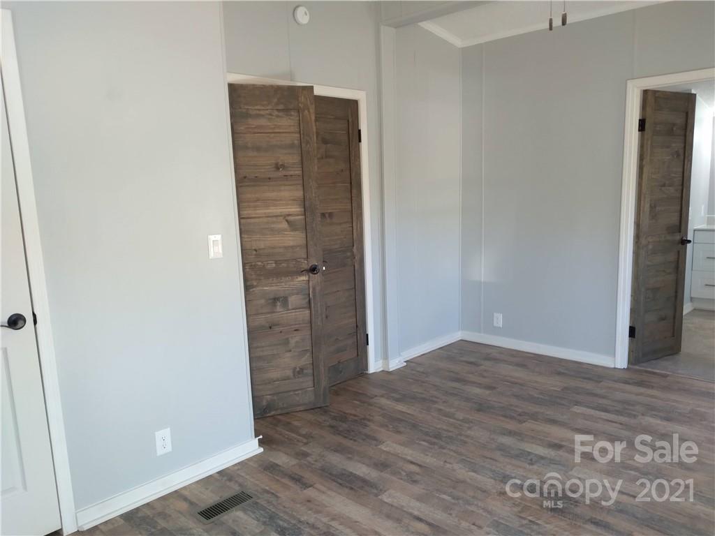 245 Roy Goins Road Rutherfordton, NC 28139 - Photo 13 of 23 an empty room with wooden floor