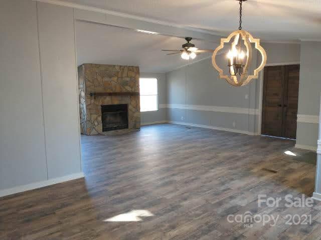 245 Roy Goins Road Rutherfordton, NC 28139 - Photo 4 of 23 a view of a livingroom with wooden floor and a fireplace