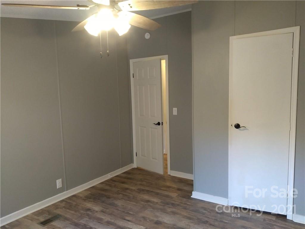 245 Roy Goins Road Rutherfordton, NC 28139 - Photo 6 of 23 a view of empty room with wooden floor and fan
