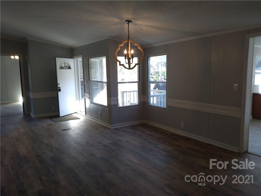 245 Roy Goins Road Rutherfordton, NC 28139 - Photo 7 of 23 a view of an empty room with wooden floor and a window