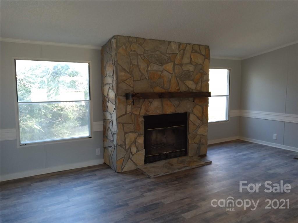 245 Roy Goins Road Rutherfordton, NC 28139 - Photo 8 of 23 a living room with a fireplace and a table