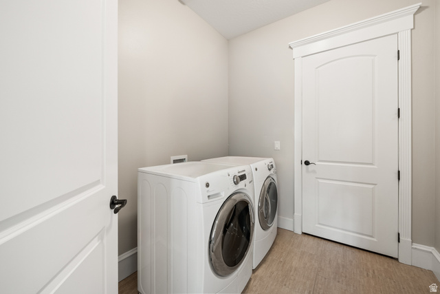 1205 North Elk Rdg Lane, Unit 202 Alpine, UT 84004 - Photo 40 of 88 Dedicated laundry space featuring neutral wall tones, durable wood-finish flooring, and white trim work
