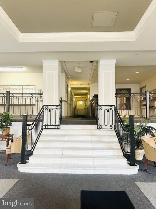 1308 Clifton Street Northwest, Unit 105 Washington, DC 20009 - Photo 1 of 21 a view of a hallway with a couches chair and a dining table with wooden floor