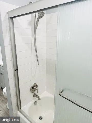 a bathroom with a shower and a sink
