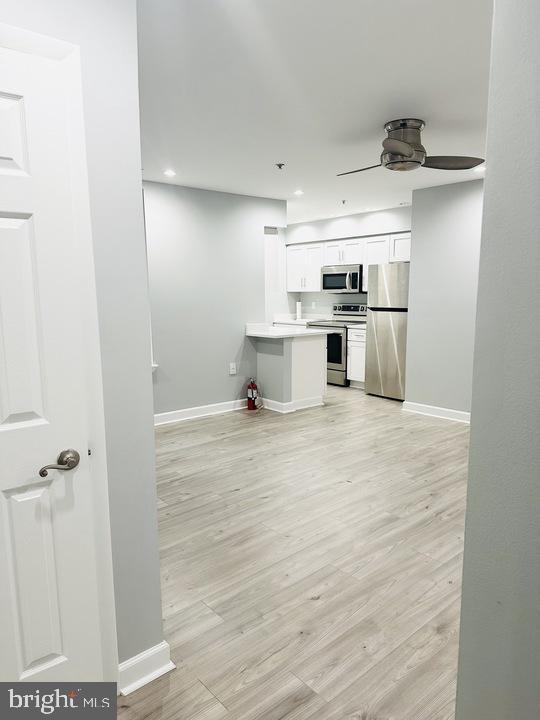 1308 Clifton Street Northwest, Unit 105 Washington, DC 20009 - Photo 4 of 21 a kitchen with a refrigerator and white cabinets