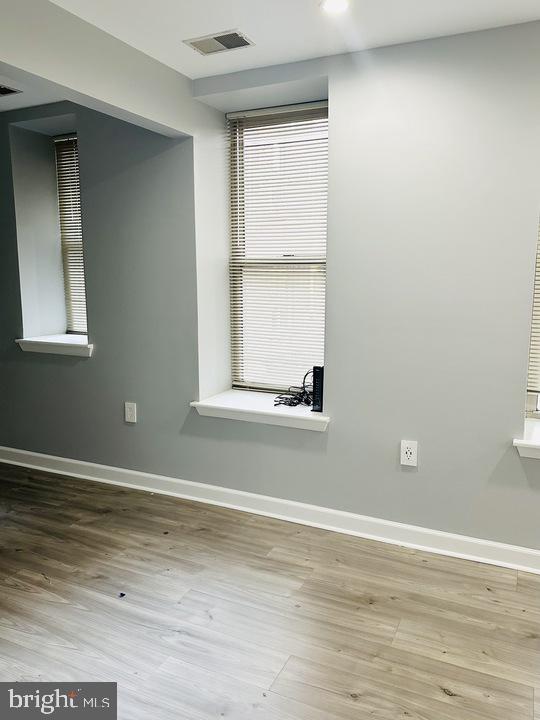 1308 Clifton Street Northwest, Unit 105 Washington, DC 20009 - Photo 9 of 21 a view of a small space with wooden floor and a window
