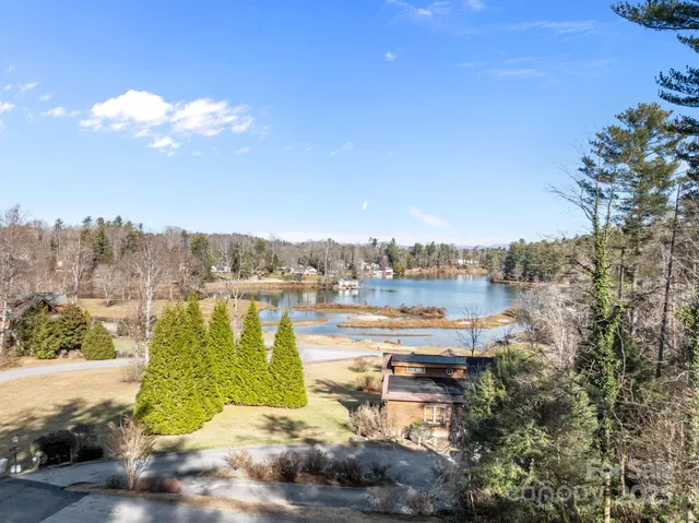 a view of a lake with houses in the back
