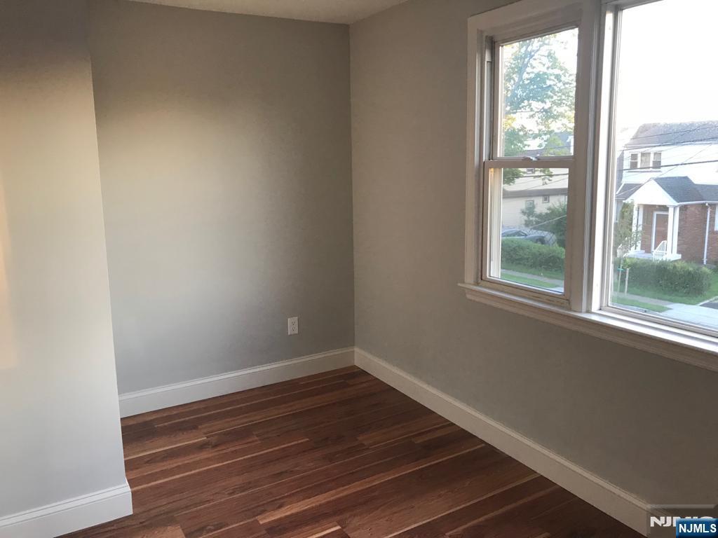 140 Prospect Street, Unit 2 Garfield, NJ 07026 - Photo 5 of 12 a room with wooden floor and windows