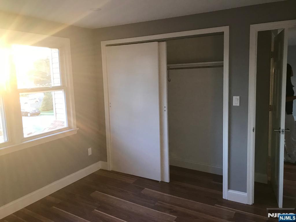 140 Prospect Street, Unit 2 Garfield, NJ 07026 - Photo 9 of 12 a view of an empty room with wooden floor and a window